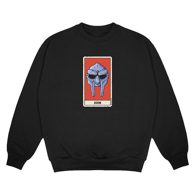 Front view of black crewneck sweater with a red tarot card style graphic featuring an illustration of MF DOOM’s mask and the word ‘DOOM’