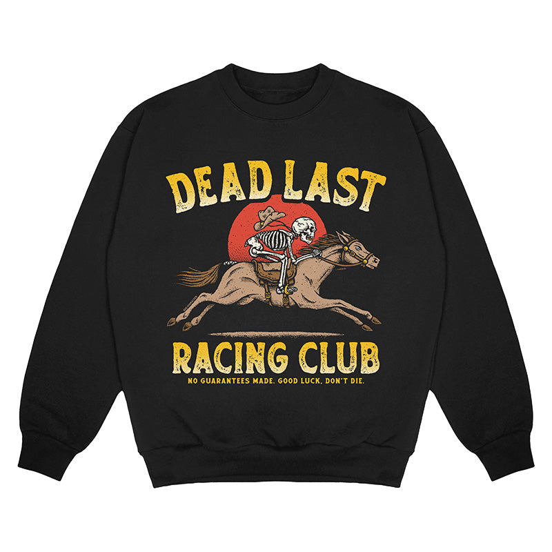 Front view of black crewneck sweater with ‘Dead Last Racing Club’ text and a skeleton cowboy riding a horse in front of a red sun