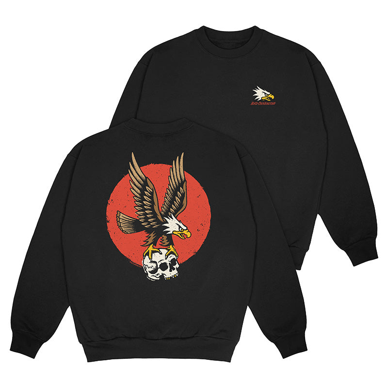 Front and Back view of black crewneck sweater with eagle logo on left chest and large flying eagle holding a skull back print
